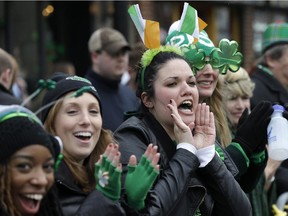 Spectators cheer during the St. Patrick's Day parade, Sunday, March 15, 2015, in Boston.