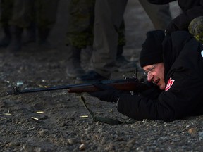 In this file picture from August, 2013, Prime Minister Stephen Harper shoots .303 Lee Enfield rifle's in Gjoa Haven, Nunavut. Harper's remarks last week on the use of firearms by citizens for self-defence have sparked a political backlash.