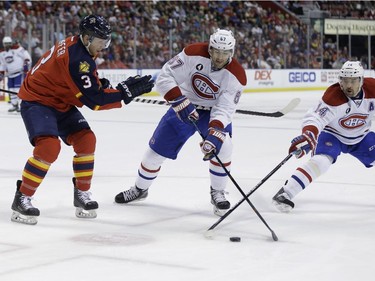 Florida Panthers defenseman Steven Kampfer (3) , Montreal Canadiens centre Alex Galchenyuk (27) and Montreal Canadiens centre Tomas Plekanec (14) go for the puck during the first period Tuesday, March 17, 2015,  in Sunrise, Fla.