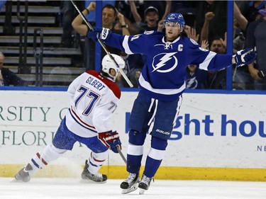 Tampa Bay Lightning's Steven Stamkos celebrates his goal in front of Montreal Canadiens' Tom Gilbert during the first period Monday, March 16, 2015, in Tampa, Fla.
