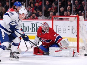 Carey Price stops the puck in front of Ondrej Palat of the Tampa Bay Lightning during action at the Bell Centre on March 10, 2015.