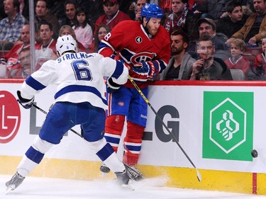 Anton Stralman of the Tampa Bay Lightning body checks Brandon Prust at the Bell Centre on Tuesday, March 10, 2015.