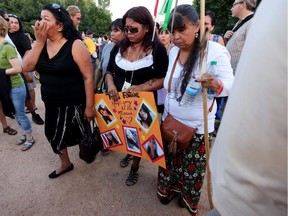Tina Fontaine, centre, attends a vigil for her daughter Tina Fontaine and Faron Hall at the Oodena Circle at The Forks in Winnipeg, Manitoba, Tuesday, August 19, 2014.