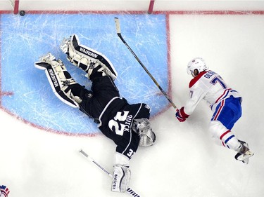 Montreal Canadiens defenceman Tom Gilbert, right, scores on Los Angeles Kings goalie Jonathan Quick during the second period of an NHL hockey game, Thursday, March 5, 2015, in Los Angeles.