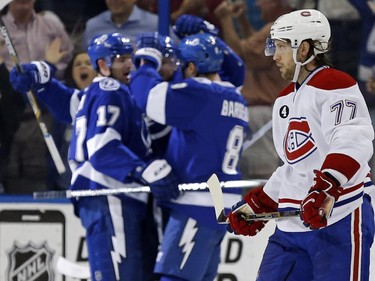 Montreal Canadiens' Tom Gilbert reacts as members of the Tampa Bay Lightning celebrate a goal during the first period Monday, March 16, 2015, in Tampa, Fla.
