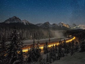 TOPSHOTS Cargo train passes through the famous 'Morant's Curve'  offering a beautiful view of the frozen Bow River and the Canadian Pacific Railway at Banff National park near Lake Louise, Canada, late on December 6, 2013.