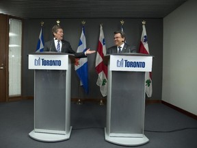 Toronto Mayor John Tory (LEFT) laughs with Montreal Mayor Denis Coderre (RIGHT) during their press conference at Toronto City Hall, Wednesday March 25, 2015.