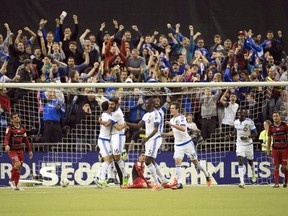 Montreal Impact's Vi­ctor Cabrera (36) celebrates with teammates after scoring the second goal against LD Alajuelense during first half CONCACAF semi-final soccer action Wednesday, March 18, 2015, in Montreal.
