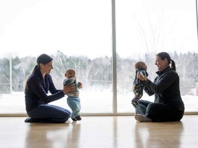 Beth Gerow, left, and her son Tetseek'eh Gerow Isaiah, 9 months, chats with Sophie Roberge and her son Sully White, 3 months, after a Mom & Tots fitness class in Wakefield on Tuesday, March 3, 2015. The small Quebec town is home to a plurality of opinions about vaccination.