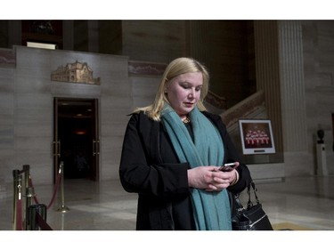 Wendy Cukier reads a message on her smart phone as she stands in the foyer of the Supreme Court of Canada in Ottawa, Friday March 27, 2015. Cukier is president of the Coalition for Gun Control.