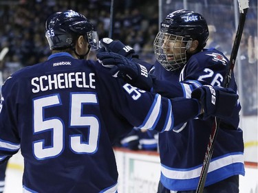 Winnipeg Jets' Mark Scheifele (55) and Blake Wheeler (26) celebrate Wheeler's goal against the Montreal Canadiens during second period NHL action in Winnipeg on Thursday, March 26, 2015.