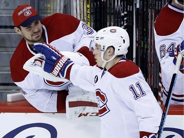 Montreal Canadiens goaltender Carey Price (31), who did not play, congratulates Brendan Gallagher (11) for scoring on the Winnipeg Jets during third period NHL action in Winnipeg on Thursday, March 26, 2015.