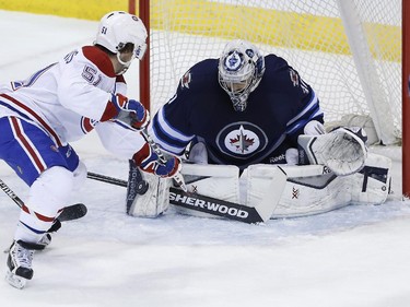 Winnipeg Jets goaltender Ondrej Pavelec (31) saves the shot by Montreal Canadiens' David Desharnais (51) during first period NHL action in Winnipeg on Thursday, March 26, 2015.
