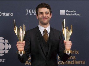 Xavier Dolan poses with two awards after winning best motion picture and best director for his film "Mommy" at the Canadian Screen Awards in Toronto on Sunday evening, March 1, 2015.