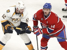 Tomas Plekanec, right, grabs stick of Mike Fisher of the Nashville Predators in Montreal, Tuesday, Jan, 20, 2015.