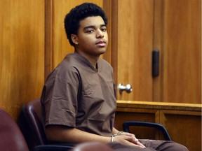 Marc Wabafiyebazu, 15, appears in adult criminal court for his arraignment, Monday, April 20, 2015, in Miami. Wabafiyebazu, son of a Canadian diplomat, has pleaded not guilty to murder charges in a Miami drug-related shootout that killed his older brother. (Walter Michot/The Miami Herald via AP, Pool)