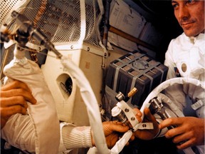 A NASA picture shows astronaut Fred W. Haise, Jr. working inside the Apollo 13 lunar module after the explosion of the ship's oxygen tanks on April 13, 1970.
