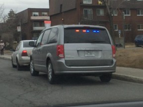 A police officer in an unmarked police vehicle pulls over a driver just off Sources Blvd. in Dollard-des-Ormeaux on Thursday, April 9, 2015.