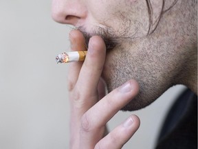 A smoker inhales as he takes a cigarette break outside a building in North Vancouver, B.C. Monday, Jan. 20, 2014.