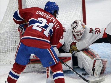 Ottawa Senators goalie Andrew Hammond (30) stops Montreal Canadiens right wing Devante Smith-Pelly (21) during first period of Game 2 NHL first round playoff hockey action Friday, April 17, 2015 in Montreal.THE CANADIAN PRESS/Ryan Remiorz