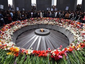 People lay flowers at the Tsitsernakaberd Armenian Genocide Memorial in Yerevan on April 21, 2015.