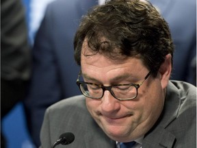 Parti Quebecois Opposition MNA Bernard Drainville looks down as he announces his decision to leave the party's leadership race on Wednesday.