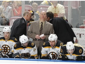 Head coach Claude Julien of the Boston Bruins looks at the scoreboard near the end of the third period against the Florida Panthers on April 9, 2015 in Sunrise, Florida.