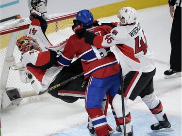Montreal Canadiens right wing Brandon Prust (8) knocks down Ottawa Senators goalie Craig Anderson (41) as Ottawa Senators defenseman Patrick Wiercioch (46) moves in during third period of Game 5 NHL first round playoff hockey action Friday, April 24, 2015 in Montreal.THE CANADIAN PRESS/Ryan Remiorz