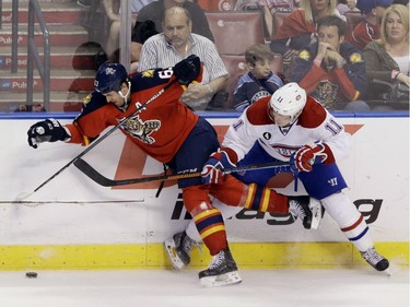 Canadiens' Brendan Gallagher and Florida Panthers' Dave Bolland battle for the puck during the third period of an NHL hockey game, Sunday, April 5, 2015, in Sunrise, Fla.