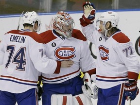 Canadiens defencemen Tom Gilbert, right, and Alexei Emelin celebrate with Carey Price after the Canadiens defeated the Florida Panthers 4-1 on Sunday, April 5, 2015, in Sunrise, Fla.