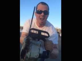 A man is seen in a video posted to Facebook using a chainsaw next to the window of a vehicle after the two drivers were involved in a road rage incident.