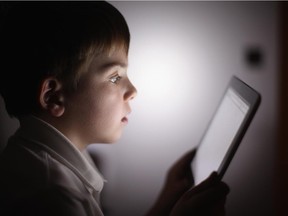 In this photograph illustration a ten-year-old boy uses an Apple Ipad tablet computer on November 29, 2011 in Knutsford, United Kingdom.