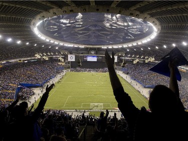 Montreal Impact fans cheer on their team during their CONCACAF Champions League final match against Mexico's Club America at the Olympic Stadium in Montreal, Wednesday April 29, 2015.