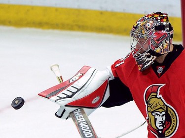 Ottawa Senators goalie Craig Anderson deflects a shot as he takes on the Montreal Canadiens during the second period of game 3 of first round Stanley Cup NHL playoff hockey action in Ottawa on Sunday, April 19, 2015.