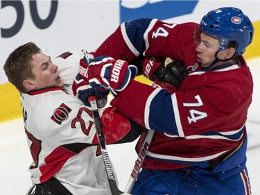 Ottawa Senators' Curtis Lazar fends off Montreal Canadiens' Alexei Emelin (74) during first period of Game 2 NHL Stanley Cup first round playoff hockey action Friday, April 17, 2015 in Montreal.