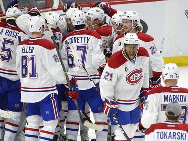 Montreal Canadiens' Devante Smith-Pelly (21) celebrates with teammates after defeating the Ottawa Senators in NHL Stanley Cup playoff hockey game, Sunday April 26, 2015, in Ottawa. The Canadiens won 2-0 to win the series.