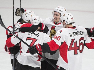 Ottawa Senators' Erik Karlsson, second left, celebrates with teammates after scoring against the Canadiens during second period of Game 5 of Eastern Conference quarter-final series at the Bell Centre on April 24, 2015.