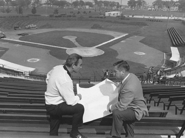 Expos' GM Jim Fanning, left, and baseball aide (Lou Martin) look over plans for temporary Jarry Park home as construction work started yesterday.
Sept. 17, 1968