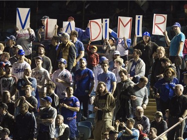 Fans show their appreciation for former Montreal Expos' Valdimir Guerrero during a pre-game ceremony as the Toronto Blue Jays face the Cincinnati Reds in  MLB exhibition play Friday, April 3, 2015, in Montreal.