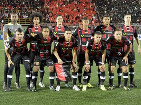 Alajuelense players pose for a photo before their  CONCACAF Champions League semifinal match against the Montreal Impact at Alejandro Morera Soto Stadium on April 7, 2015.