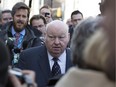 Former Conservative Senator Mike Duffy is swarmed by media as he approaches the Ottawa Courthouse to begin his first day of trial on April 7 in Ottawa Ont. (Graeme Murphy / Ottawa Citizen)
