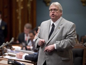Quebec Health Minister Gaétan Barrette rises during question period Tuesday, April 28, 2015 at the legislature in Quebec City.