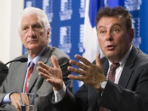 Co-owner of La Residence du Havre, Roch Bernier, right, gestures as he responds to media as his lawyer Guy Bertrand, left, looks on, in Quebec City on Monday, August 11, 2014.