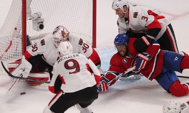 Montreal Canadiens' Devante Smith-Pelly (21) tries to get to puck next to Ottawa Senators goalie Andrew Hammond during third period action in Montreal on Friday April 17, 2015. The Montreal Canadiens meet the Ottawa Senators in the first round of the NHL playoffs.