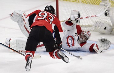 Montreal Canadiens goalie Carey Price sprawls in front of a leaping Ottawa Senators' Mika Zibanejad (93) during third period NHL playoff action in Ottawa, Sunday, April 26, 2015.