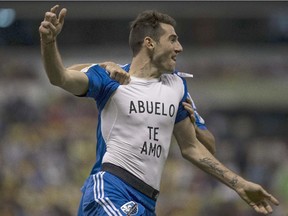 Ignacio Piatti of Canada's Montreal Impact celebrates scoring a goal against Mexico's America by showing his undershirt with the message that reads in Spanish "Grandfather I love you" during a CONCACAF Champions league match in Mexico City, Wednesday, April 22, 2015.