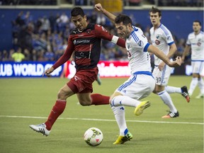 Montreal Impact's Ignacio Piatti and LD Alajuelense's Johnny Acosta battle for the ball during CONCACAF semi-final action on March 18, 2015, at Olympic Stadium.
