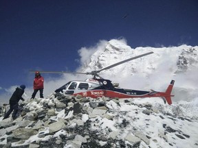 In this photo provided by Azim Afif, a helicopter prepares to rescue people from camp 1 and 2 at Everest Base Camp, Nepal on Monday, April, 27, 2015. On Saturday, a large avalanche triggered by Nepal's massive earthquake slammed into a section of the Mount Everest mountaineering base camp, killing a number of people and left others unaccounted for. Afif and his team of four others from the Universiti Teknologi Malaysia (UTM) all survived the avalanche. (Azim Afif via AP)