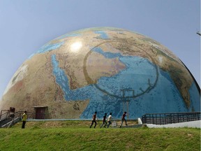 Indian children play around 'Planet Earth Pavilion' in the campus of Gujarat Science City on the outskirts of Ahmedabad on April 22, 2015 on Earth Day.