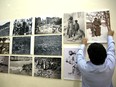 In the Armenian Quarter in Jerusalem's Old City, a man hangs pictures for an exhibition marking the 100th anniversary of the mass killings of Armenians under the Ottoman Empire in 1915.